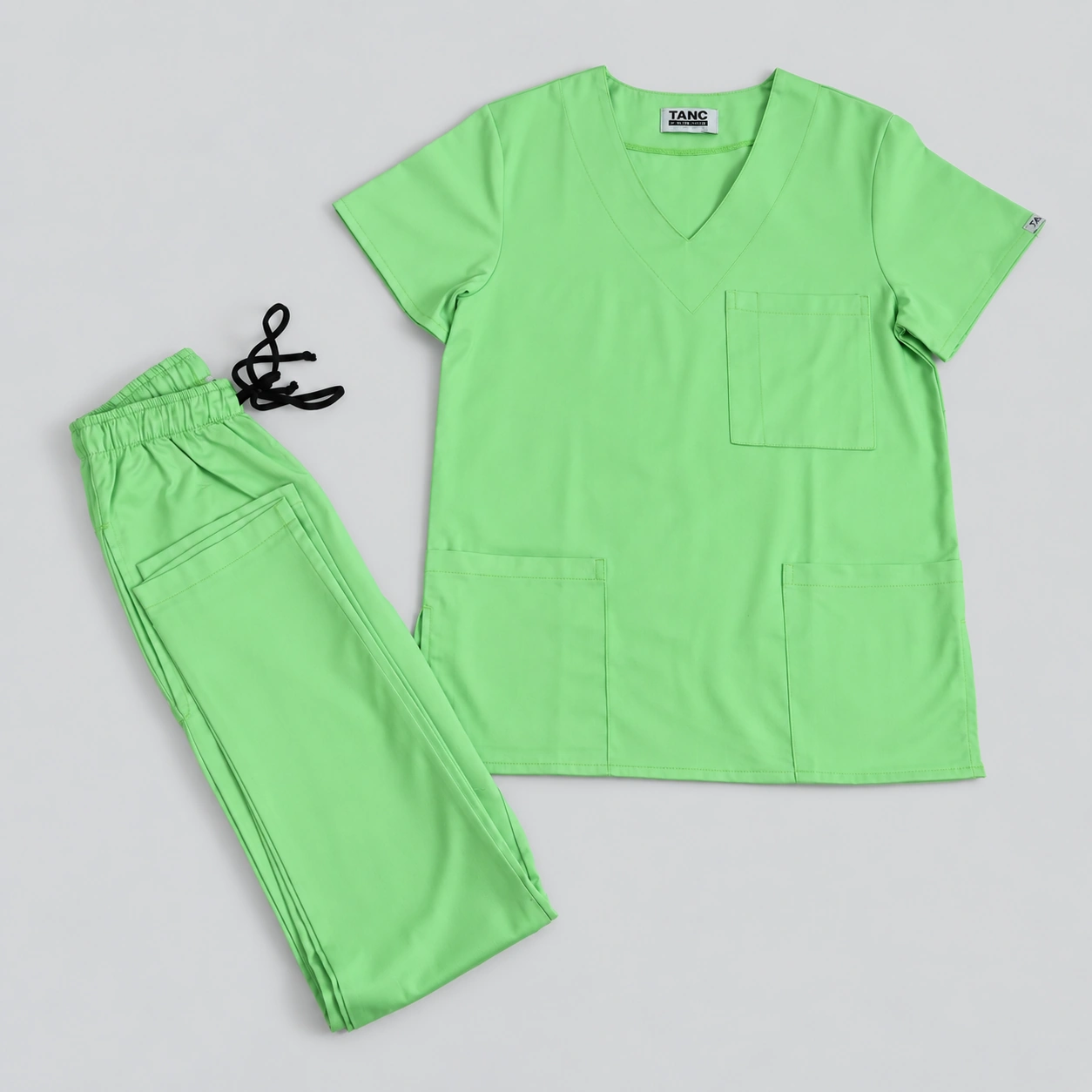 lime green scrubs set flat lay